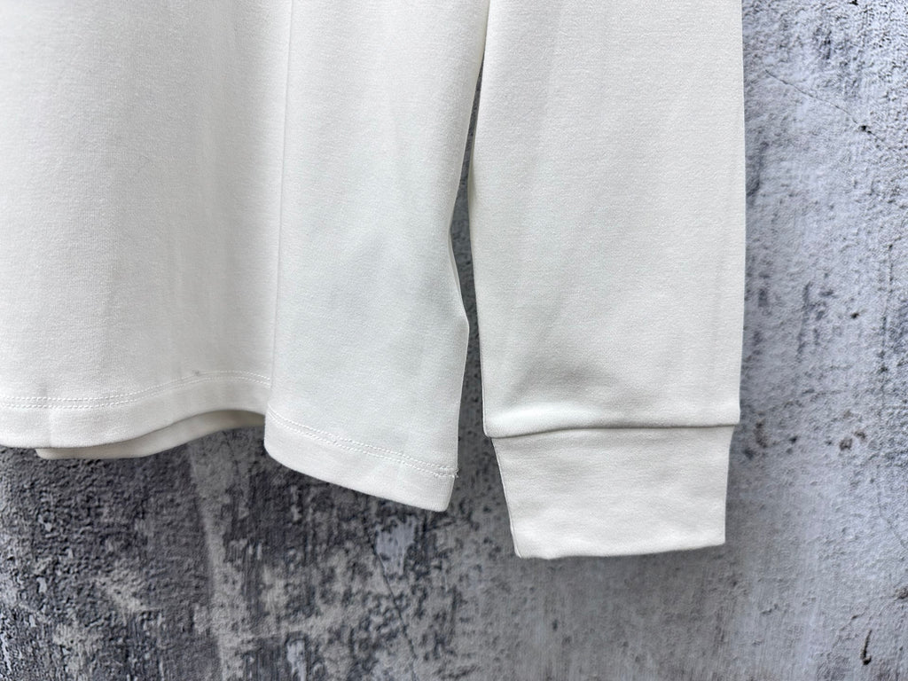 White long-sleeve T-shirt with ribbed cuffs and straight hem