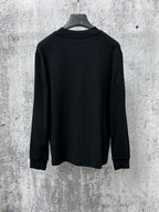 Black long-sleeve sweatshirt back view on hanger