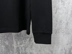 Black long-sleeve sweatshirt with ribbed cuffs and straight hem