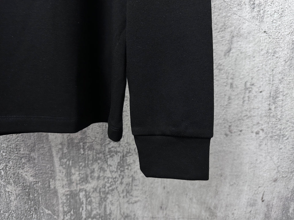 Black long-sleeve sweatshirt with ribbed cuffs and hem