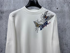 White long-sleeve crew-neck top with Dior floral and butterfly graphic.