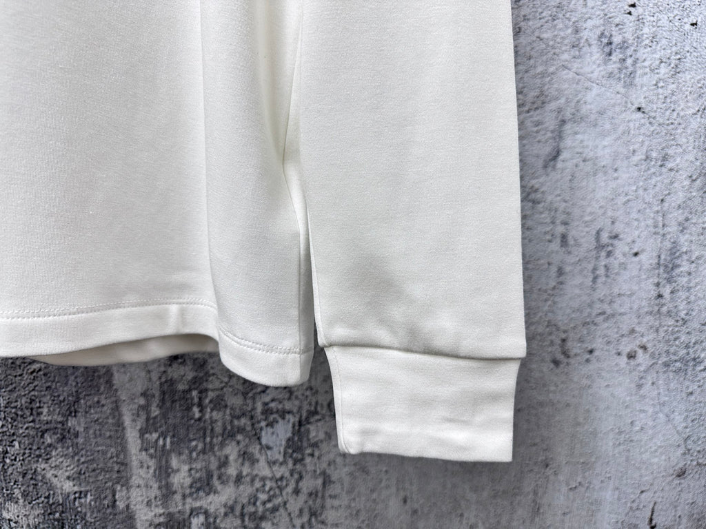 White sweatshirt sleeve hem and cuff detail.