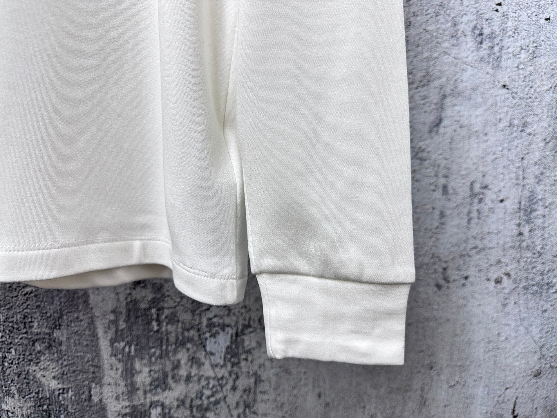 White sweatshirt sleeve hem and cuff detail.