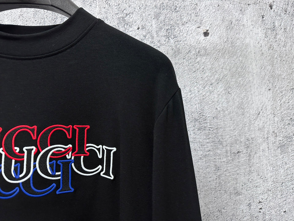 Black long-sleeve crewneck T-shirt with red and blue Gucci logo