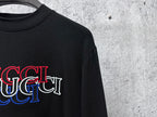 Black long-sleeve crewneck T-shirt with red and blue Gucci logo