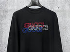 Black long-sleeve crewneck T-shirt with red and blue Gucci logo on chest