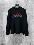 Black long-sleeve crewneck T-shirt with multicolor Gucci logo graphic