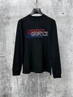 Black long-sleeve crewneck T-shirt with multicolor Gucci logo graphic