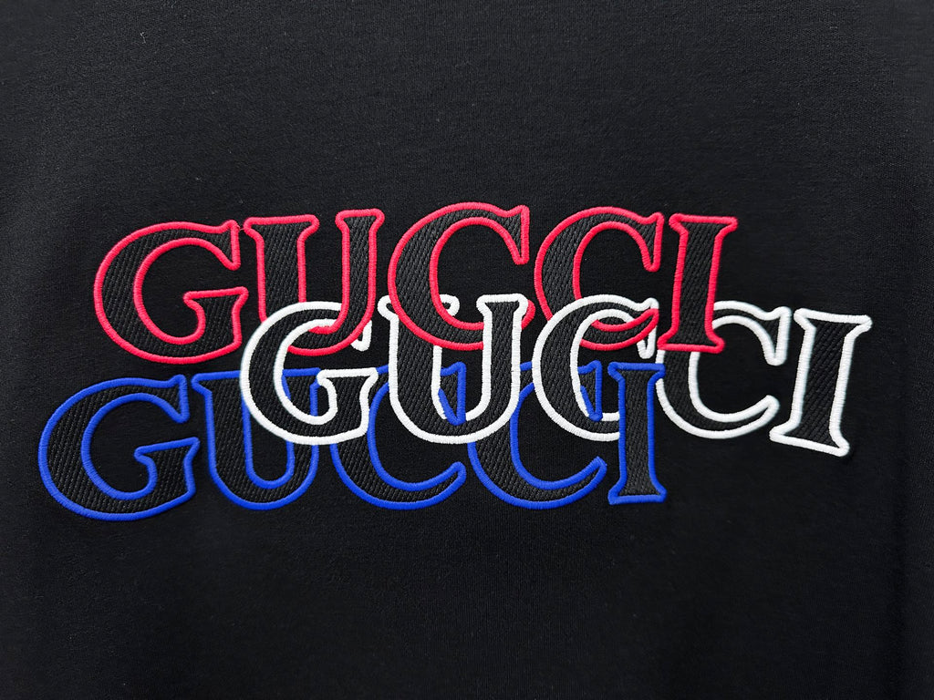 Black long-sleeve T-shirt with large red and blue Gucci logo print