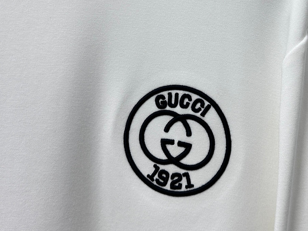 White T-shirt with black round Gucci 1921 emblem