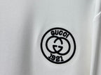White T-shirt with black round Gucci 1921 emblem