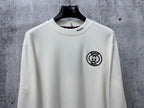 White long-sleeve T-shirt with Gucci round logo patch on left chest