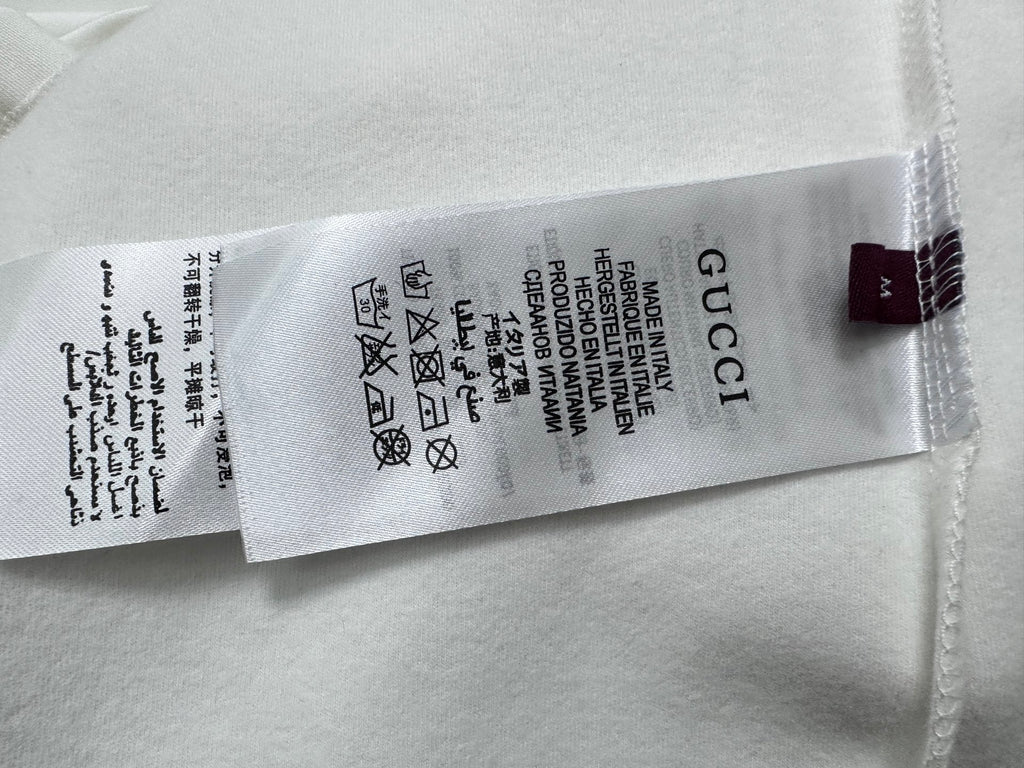 White T-shirt size label and care symbols with Gucci text