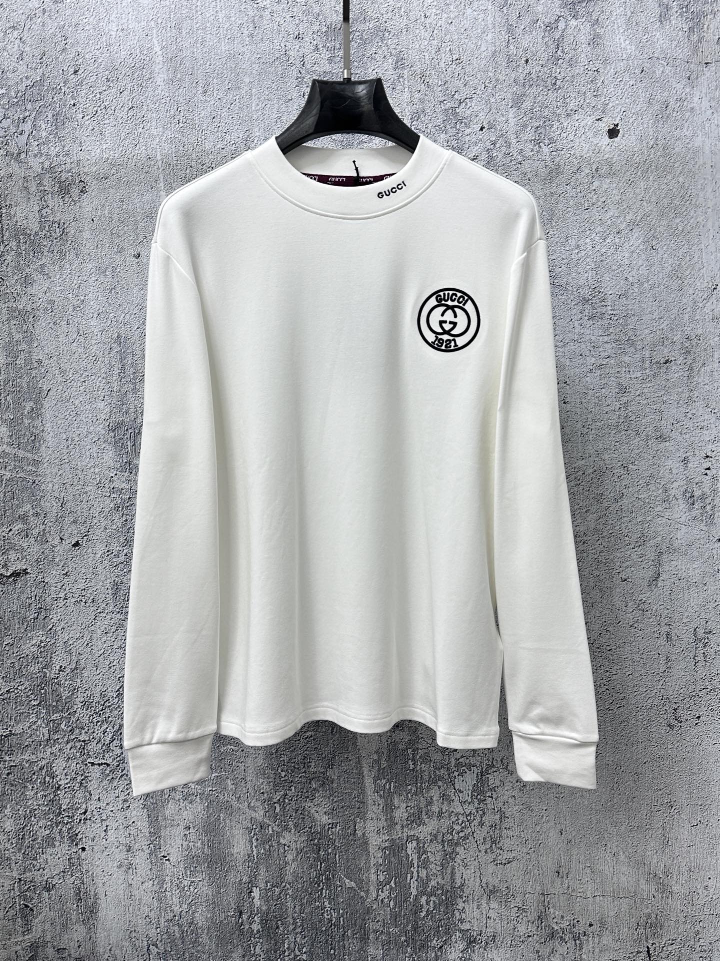 White long-sleeve T-shirt with Gucci patch at chest