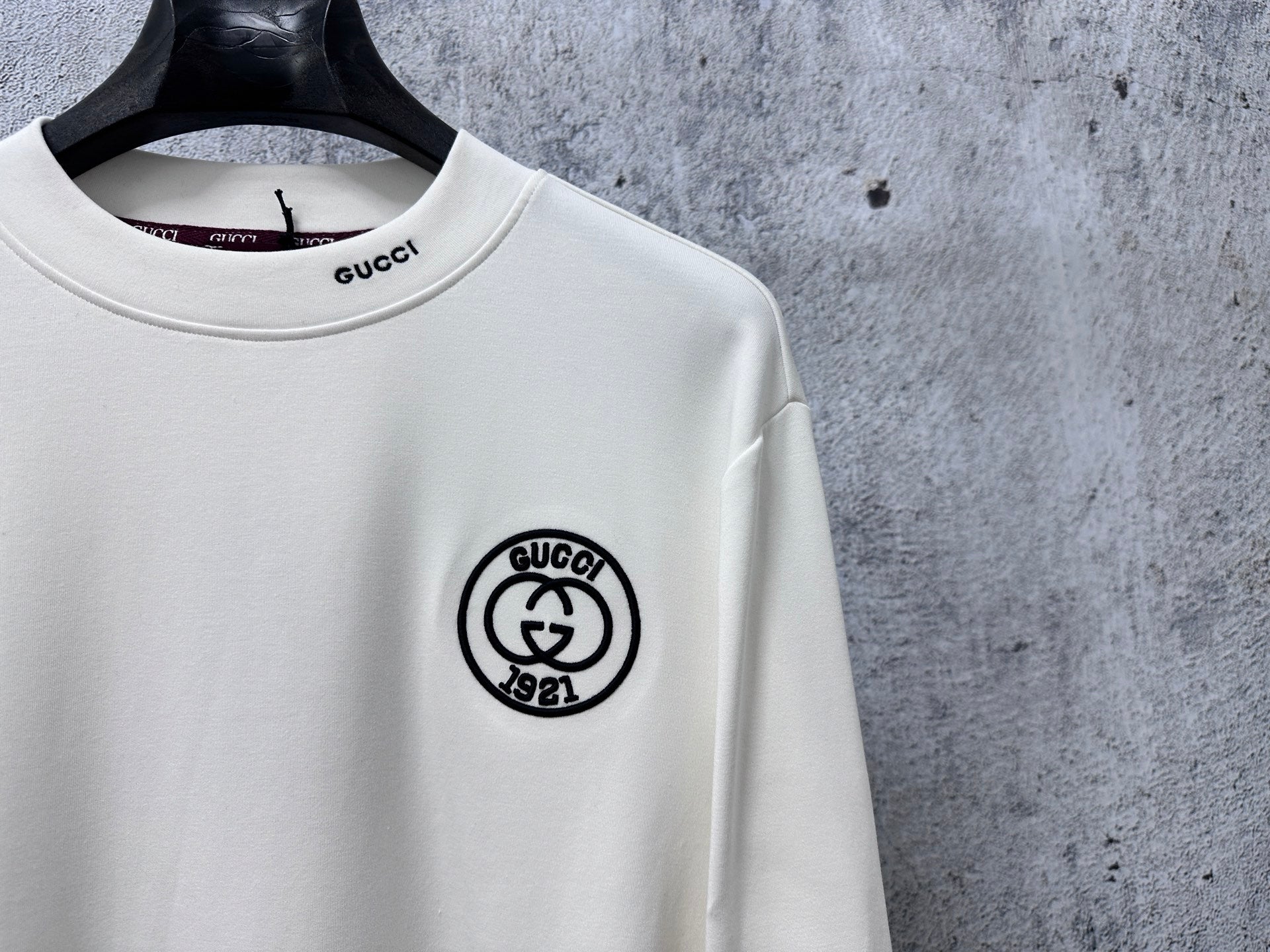 White long-sleeve T-shirt with round Gucci 1921 logo patch