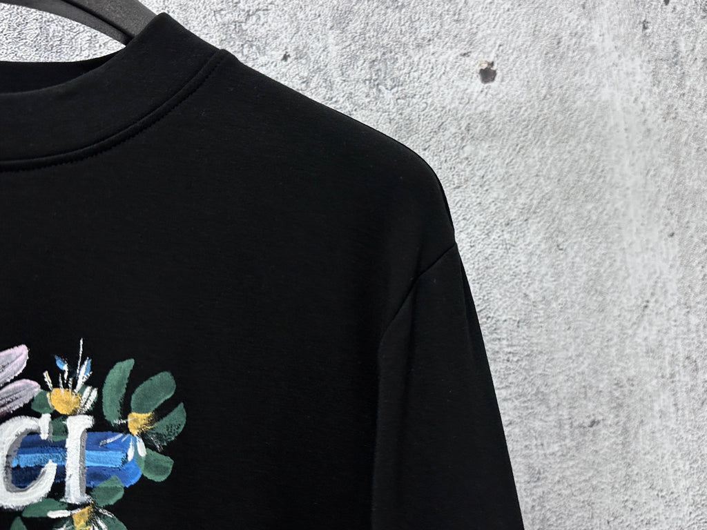 Black sweatshirt close-up of Gucci floral graphic on chest