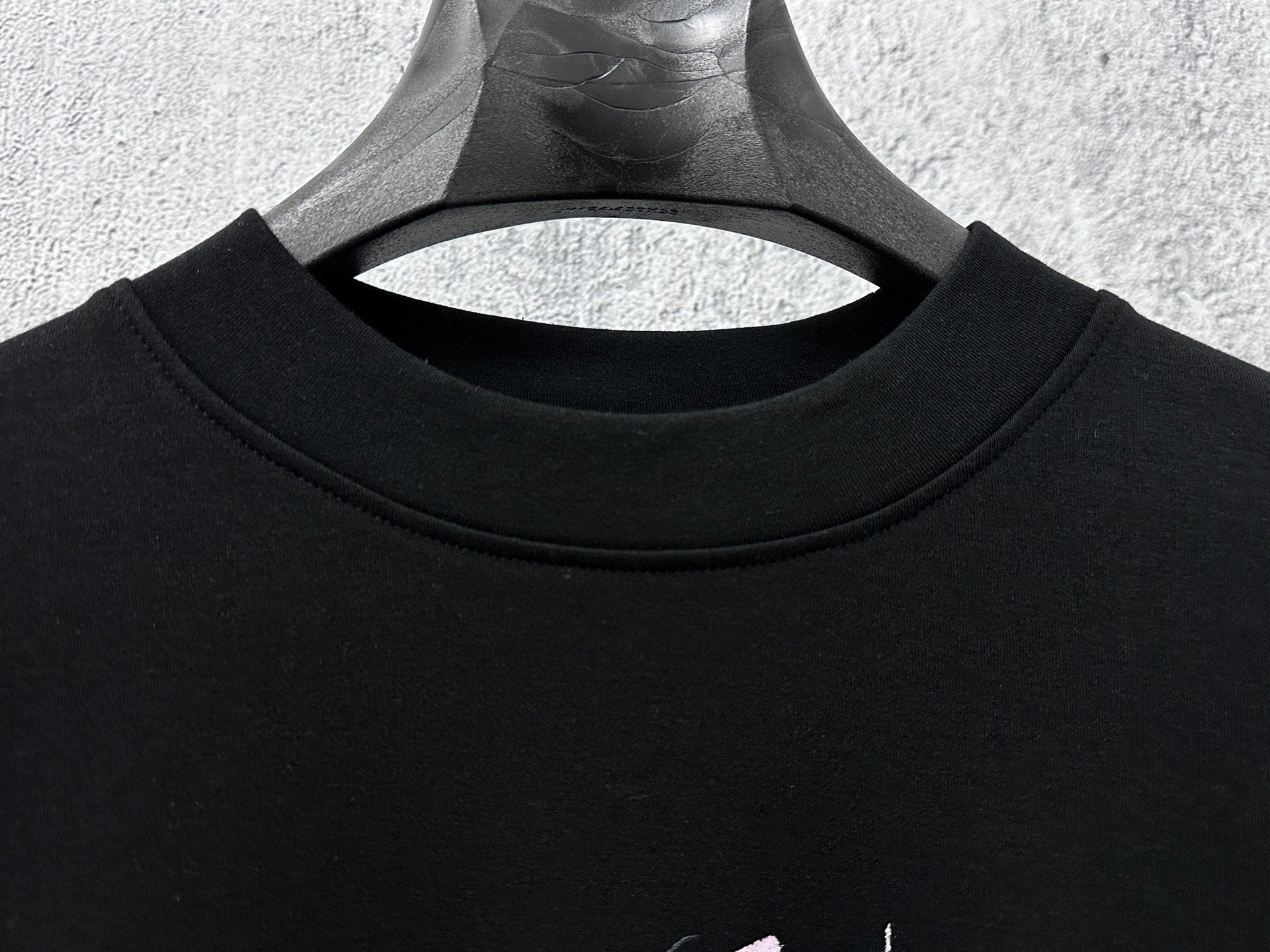 Black crew-neck sweatshirt with ribbed collar
