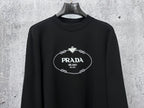 Black long-sleeve sweatshirt with PRADA Milano oval logo on chest