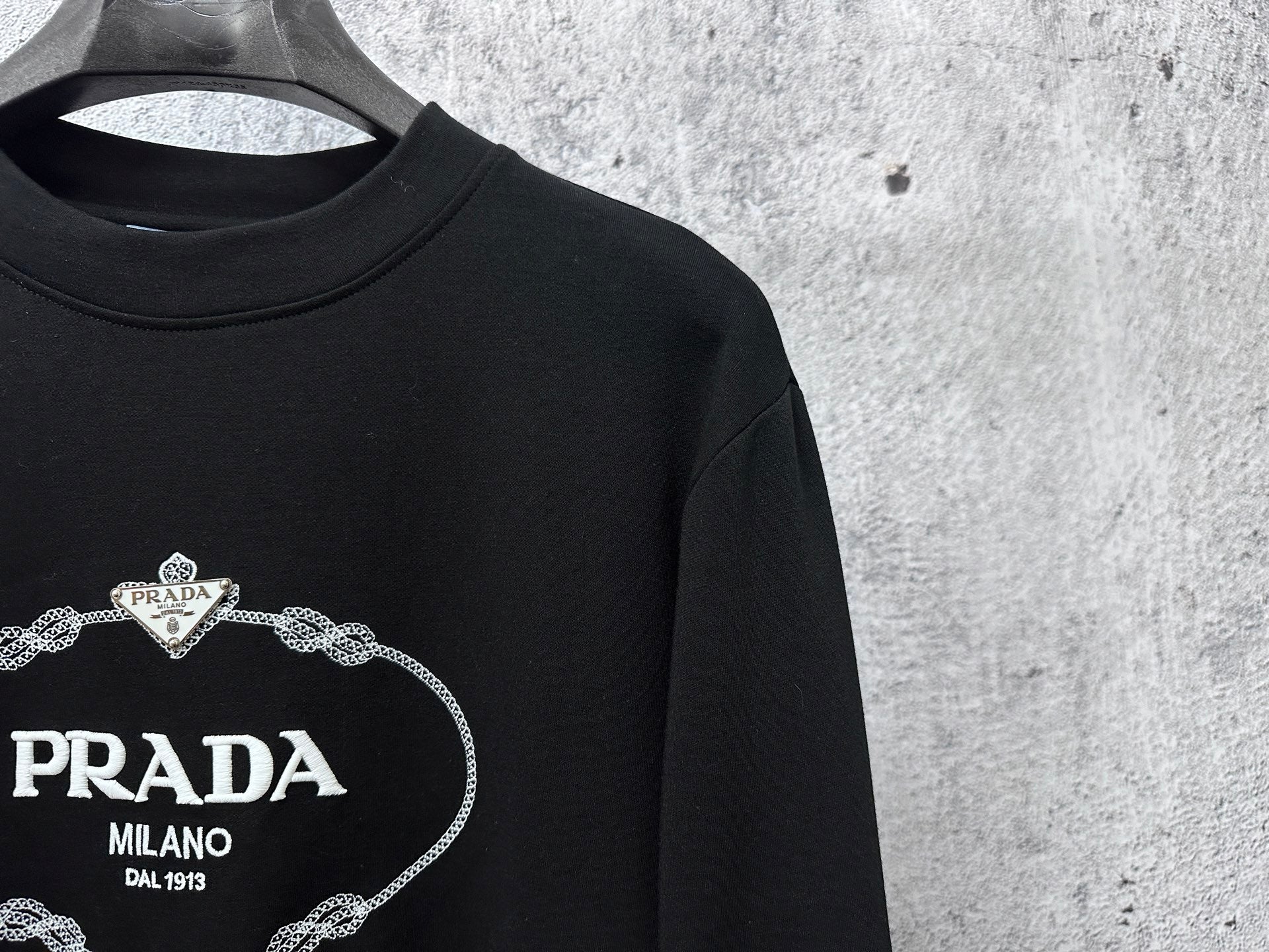 Black long-sleeve sweatshirt neckline and PRADA Milano chest logo detail