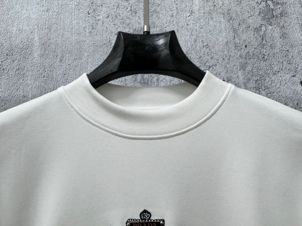 White long-sleeve sweatshirt with ribbed crew neck and small chest logo