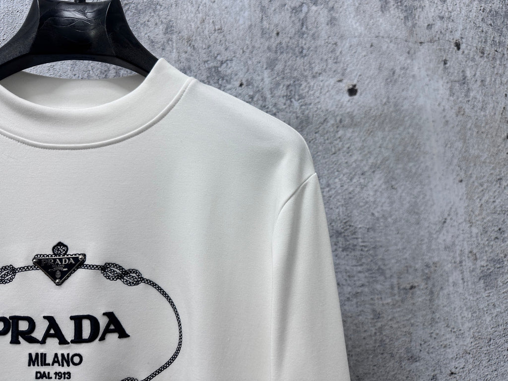 White long-sleeve sweatshirt with PRADA Milano logo close-up