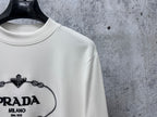 White long-sleeve sweatshirt with PRADA Milano logo close-up