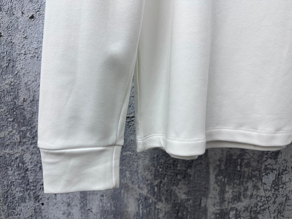 White sweatshirt hem and sleeves, showing ribbed cuffs and bottom edge