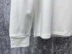 White sweatshirt hem and sleeves, showing ribbed cuffs and bottom edge