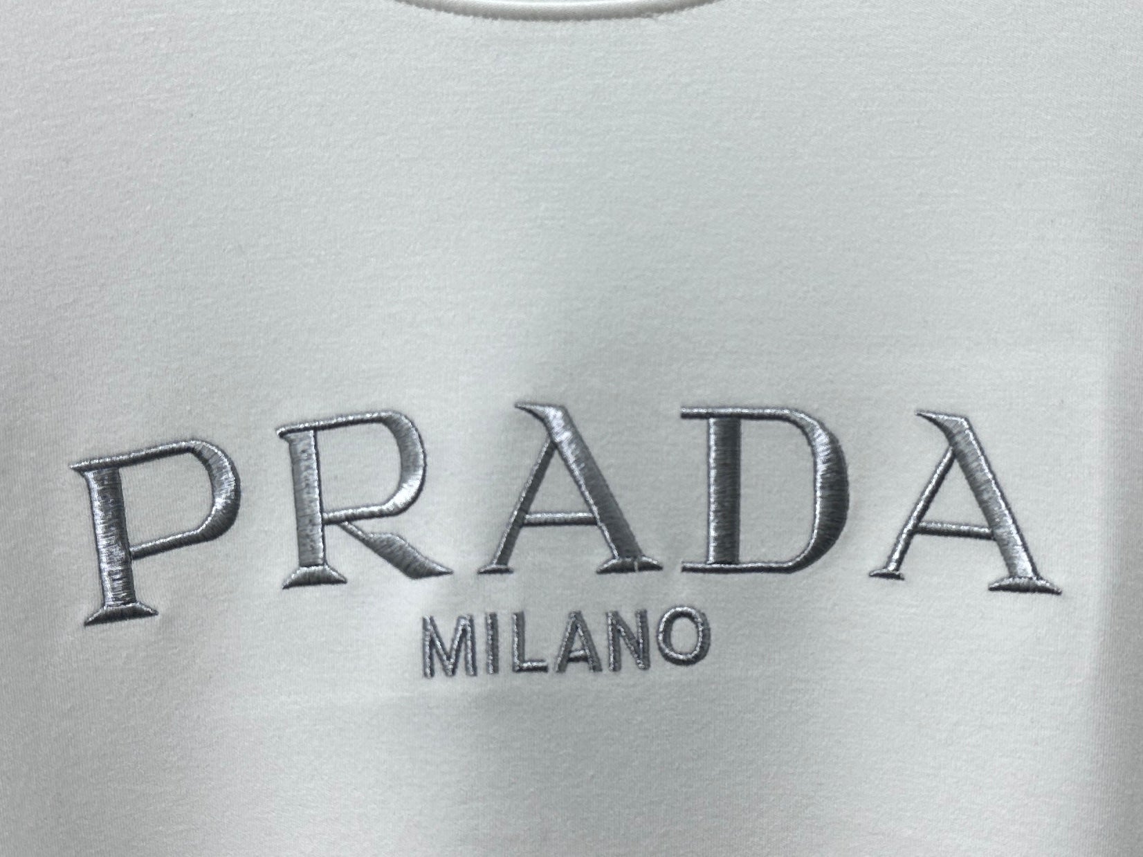 PRADA Milano logo on cream sweatshirt fabric