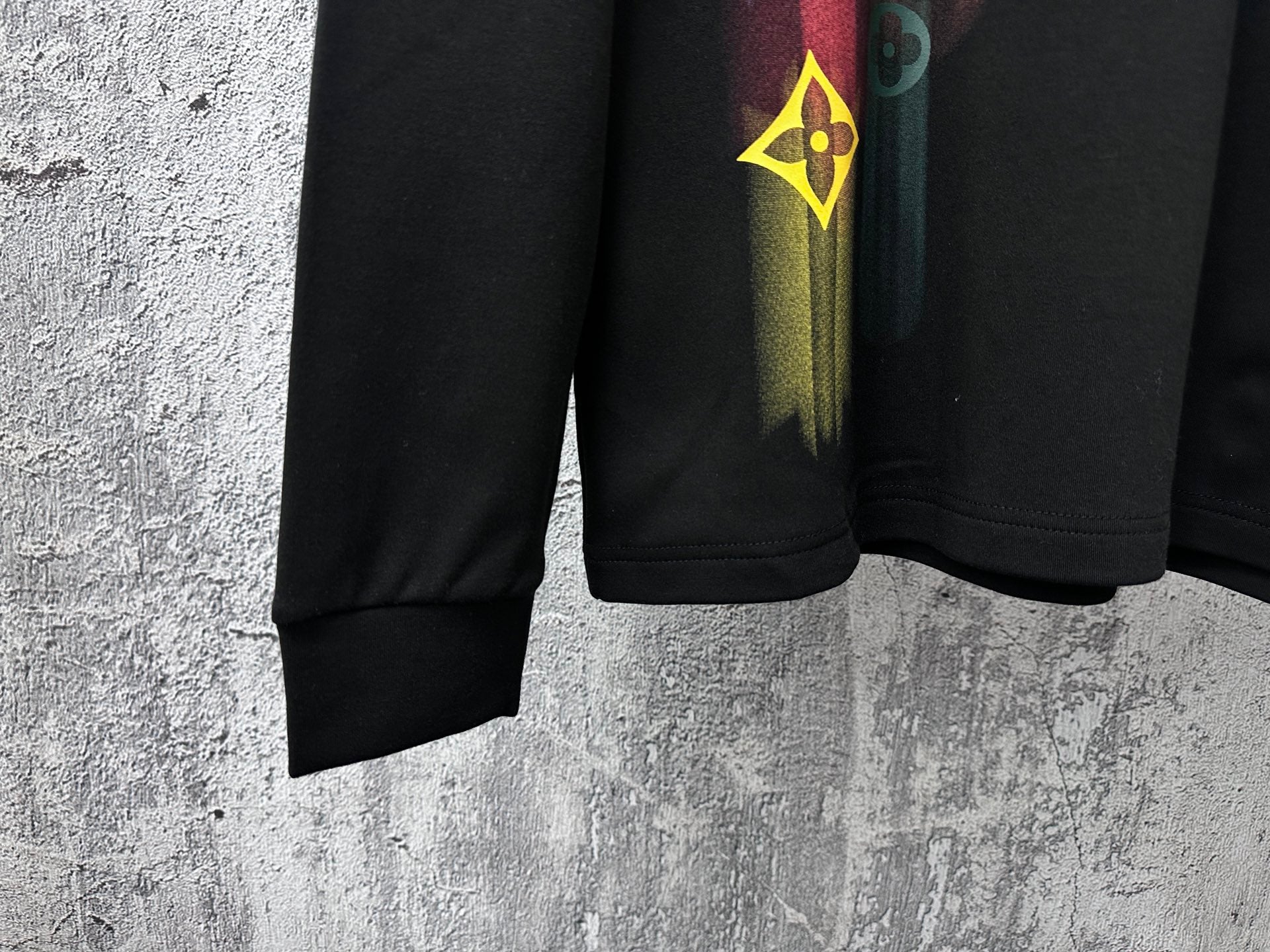 Louis Vuitton long-sleeve sweatshirt lower front, black cuffs with colorful vertical graphic