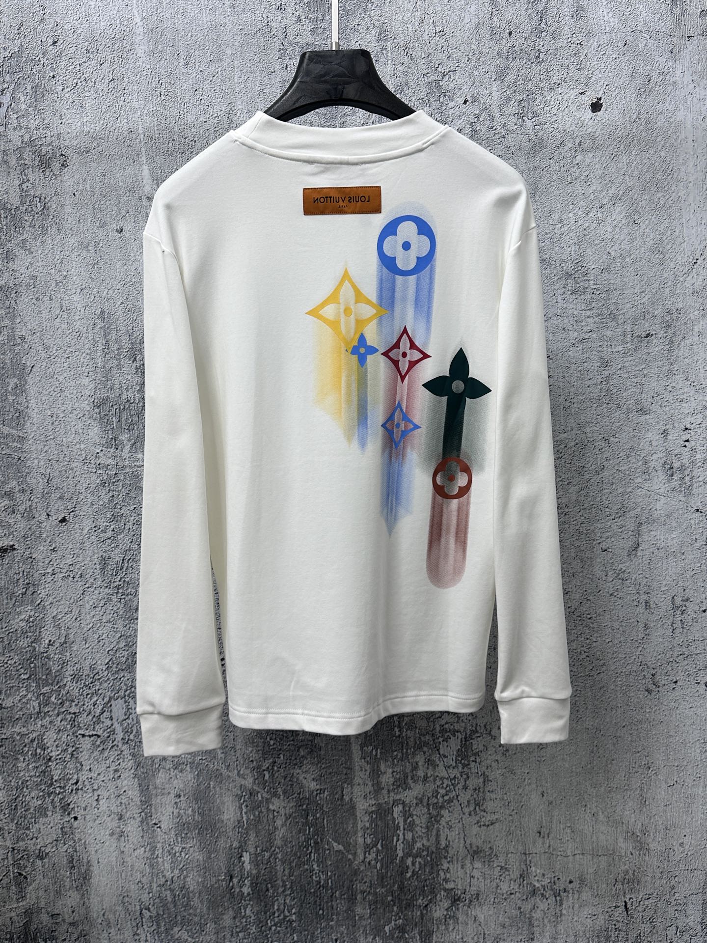 White long-sleeve sweatshirt with colorful back print and Louis Vuitton neckline label
