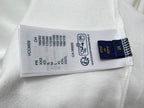 White sweatshirt with stitched size and care tag, including Louis Vuitton branding