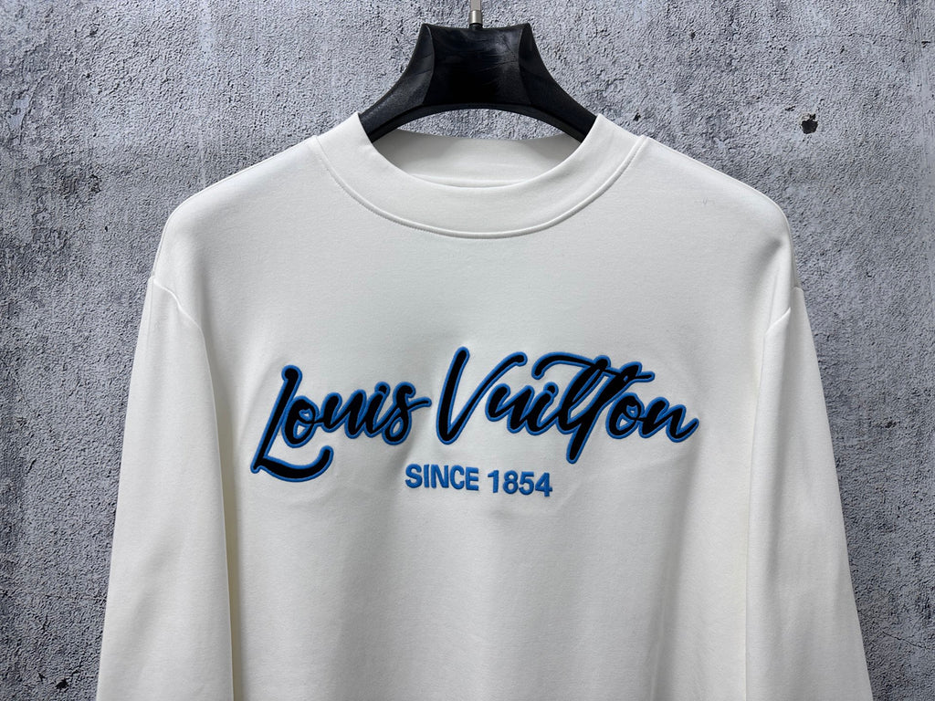 White Louis Vuitton long-sleeve T-shirt front view with blue logo and 'Since 1854'