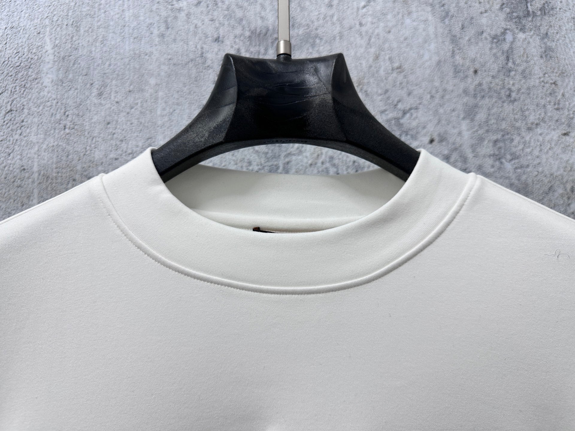 White Louis Vuitton long-sleeve T-shirt crew neck close-up with seam detail