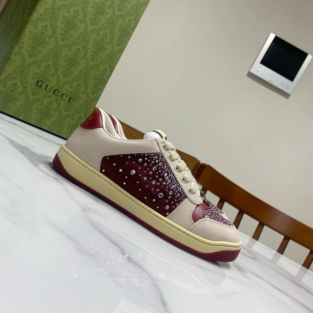 Unisex luxury sneakers by Gucci, cream leather-look with burgundy studded side panel.