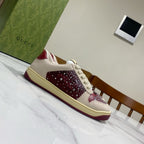Unisex luxury sneakers by Gucci, cream leather-look with burgundy studded side panel.