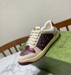 Unisex luxury sneakers by Gucci, cream leather-look with burgundy sparkle panel and cream sole.