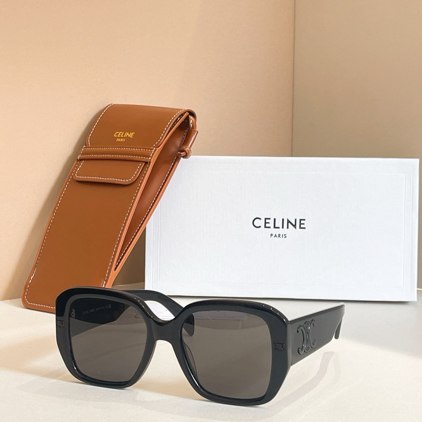 Black square sunglasses with smoky lenses and C-shaped temple detailing