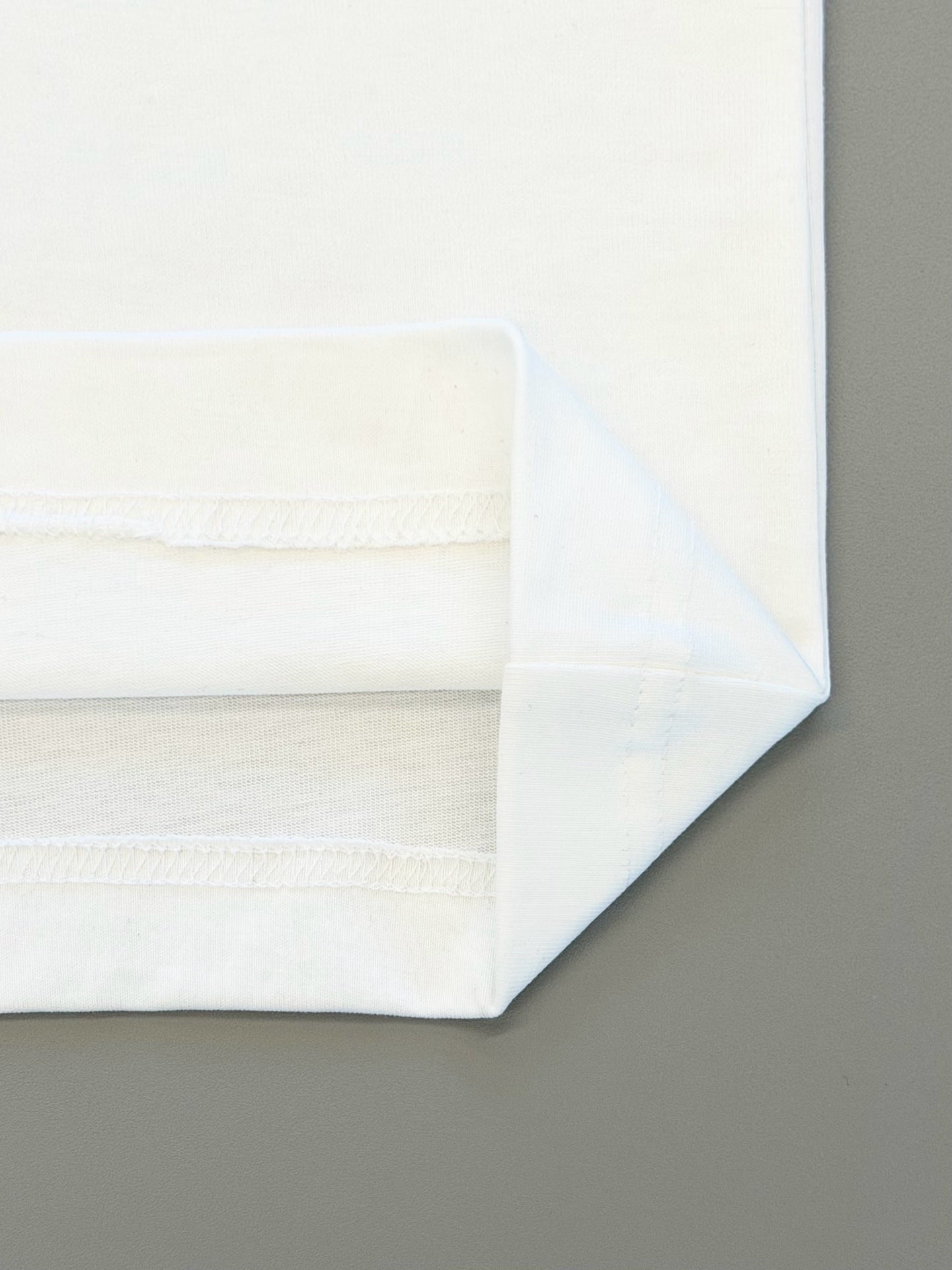 Folded white T-shirt hem with ribbed trim