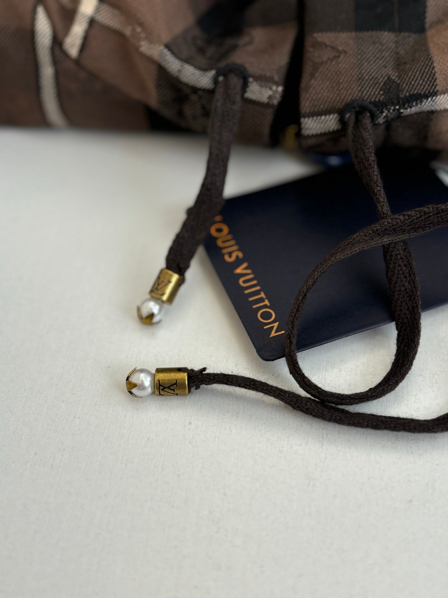 Plaid jacket drawstring with black cord and Louis Vuitton label tips