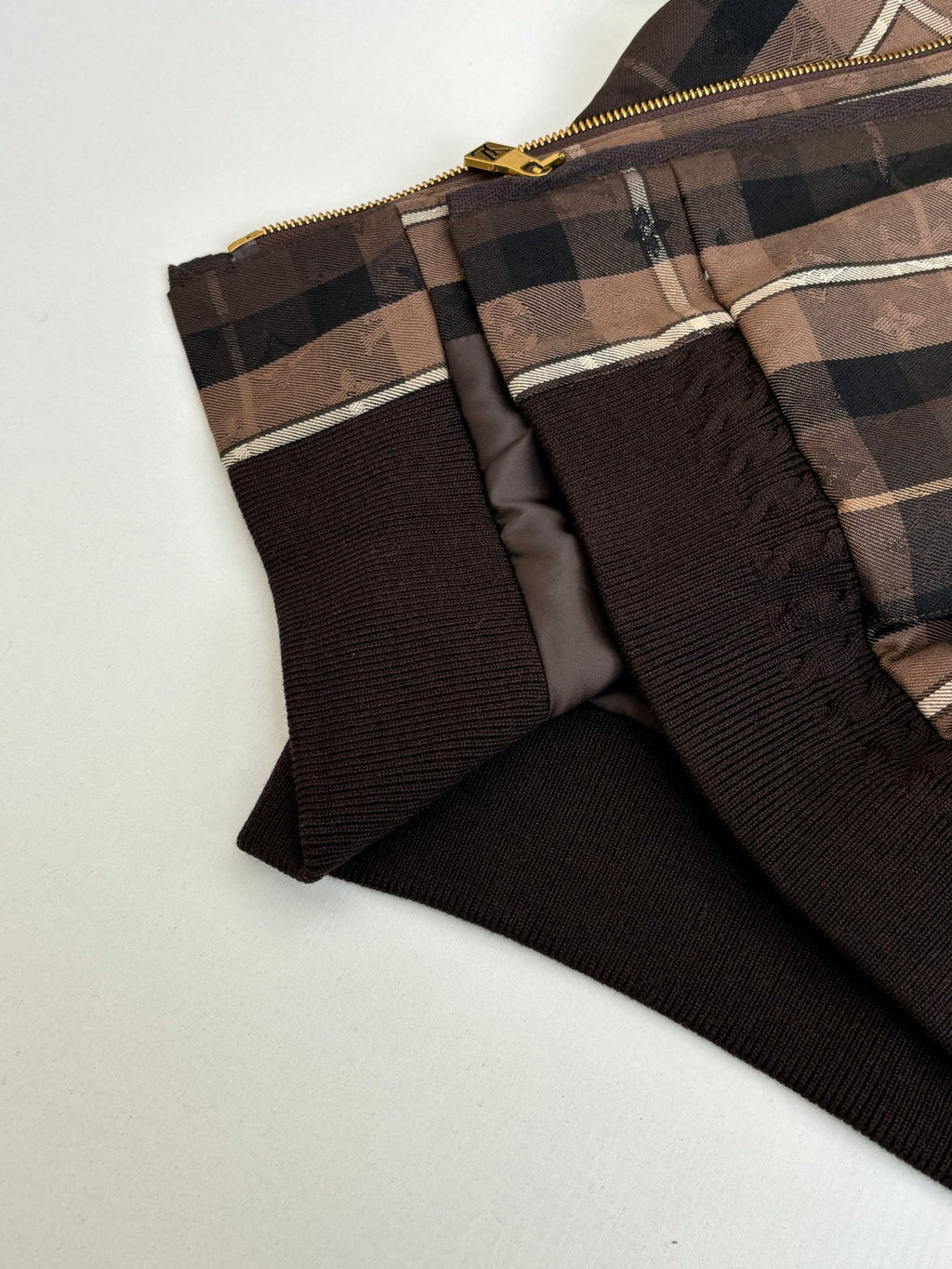 Plaid jacket panel with black lining and gold zip hardware