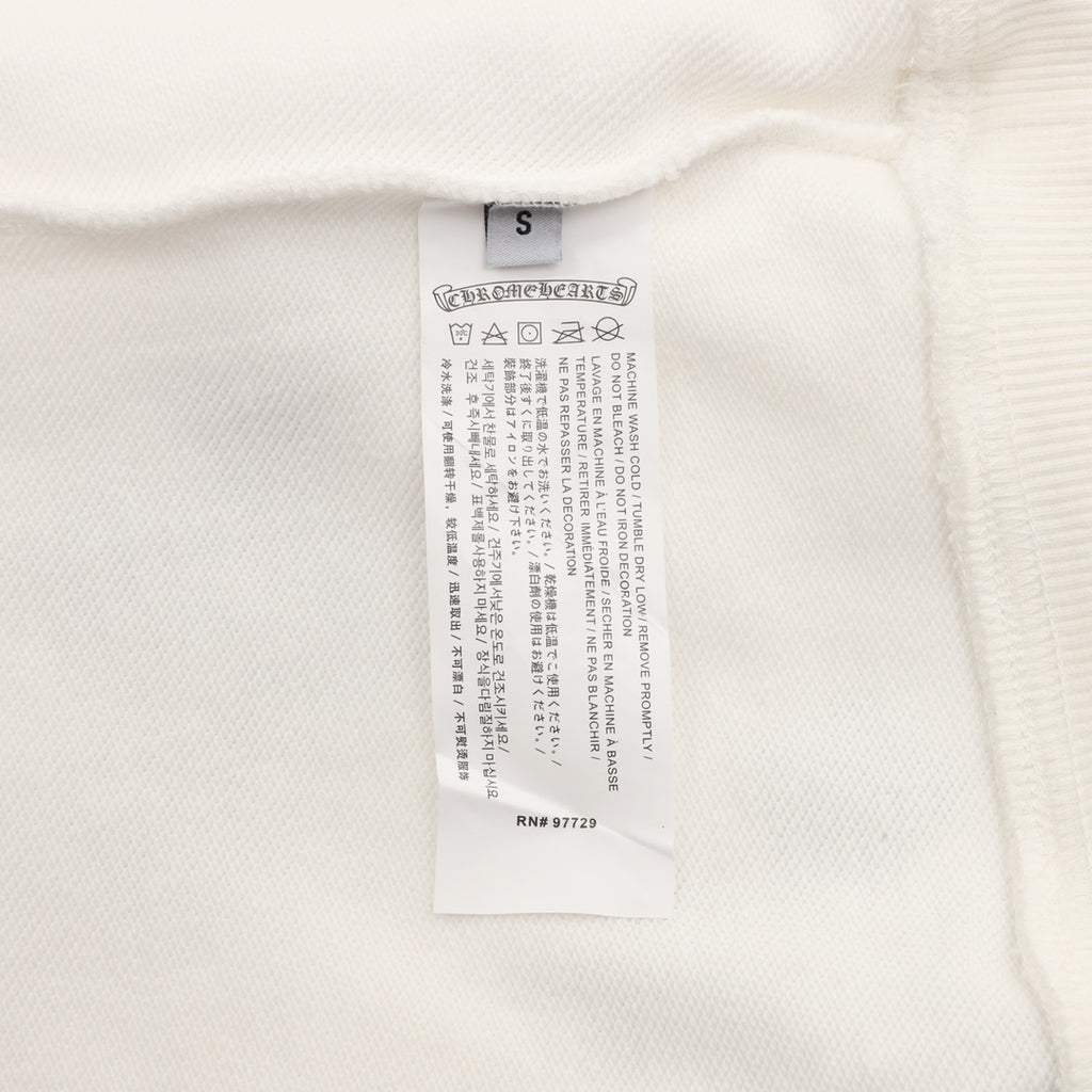 White sweatshirt interior size and care label near the neckline