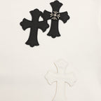 White sweatshirt with black embroidered cross appliques and a small bow detail