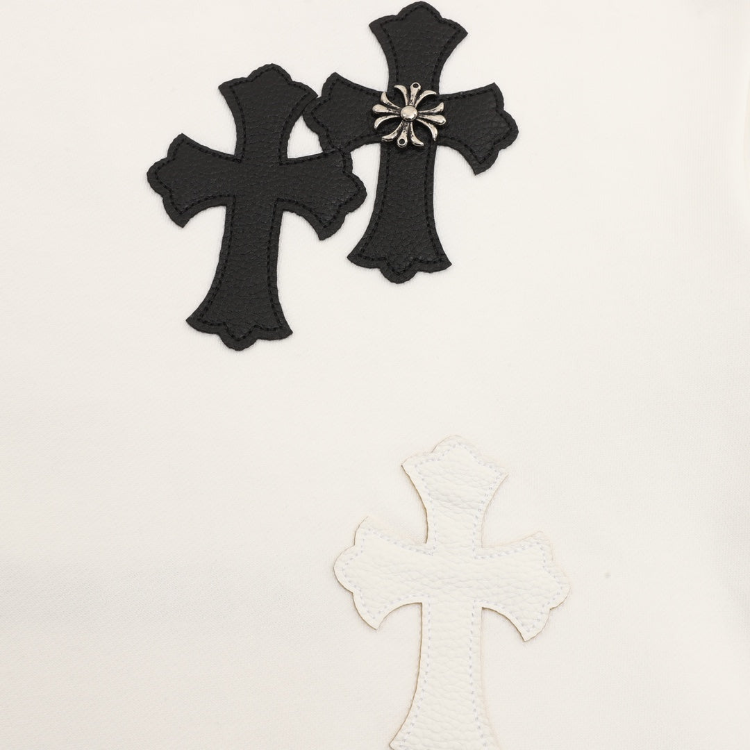 White sweatshirt with black embroidered cross appliques and a small bow detail