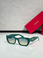 Sunglasses with green frames and light-tinted lenses, Prada logo on temple.