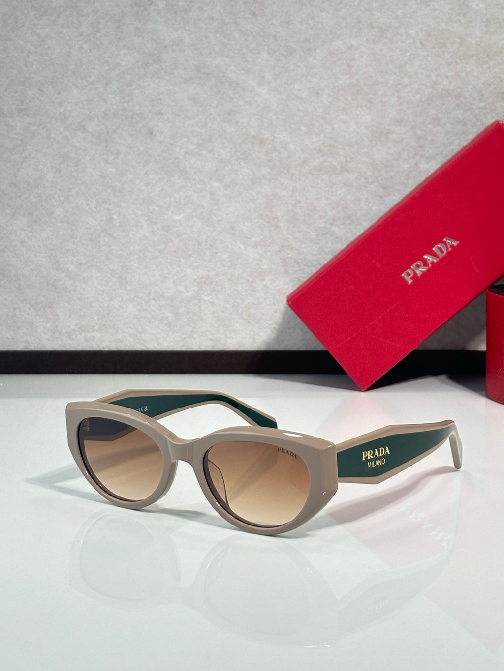 Prada glasses, beige frames with green-tinted lenses