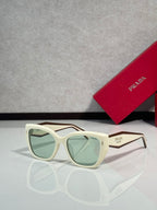 Prada glasses with white frames and green tinted lenses
