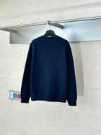 Navy long-sleeve knit sweater with crew neck, shown from the back on a hanger