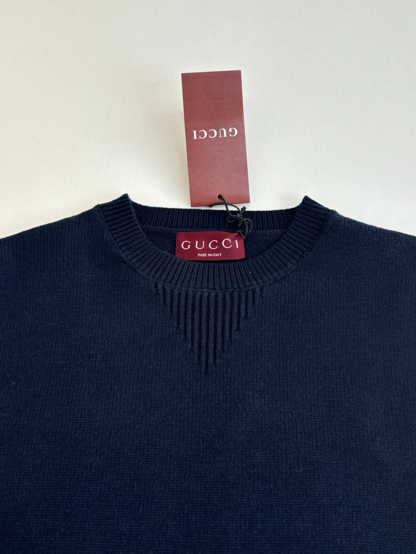 Navy ribbed crew-neck knit sweater with Gucci label at the collar