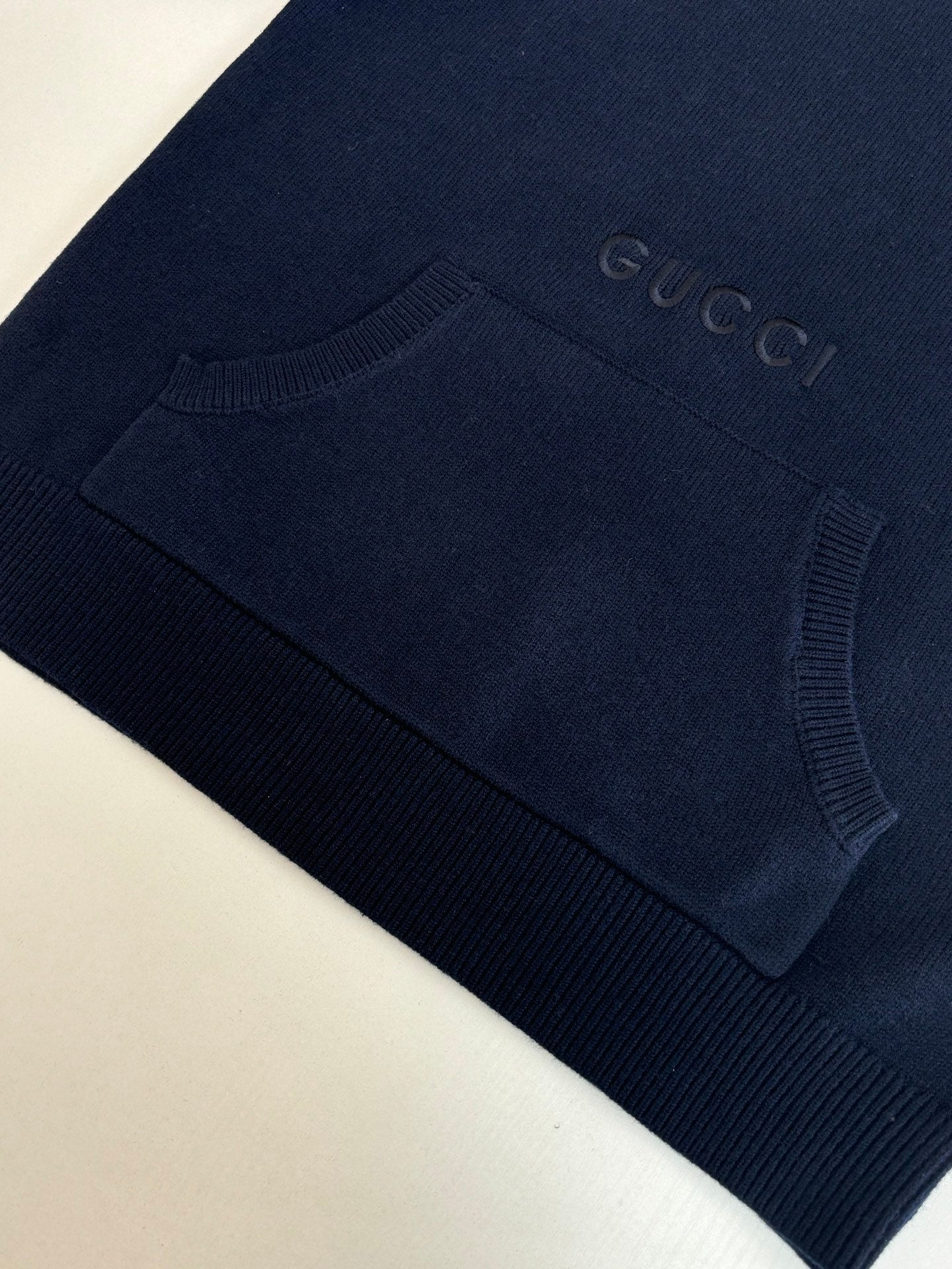 Navy crew-neck knit sweater sleeve and cuff with ribbed hem and subtle Gucci logo